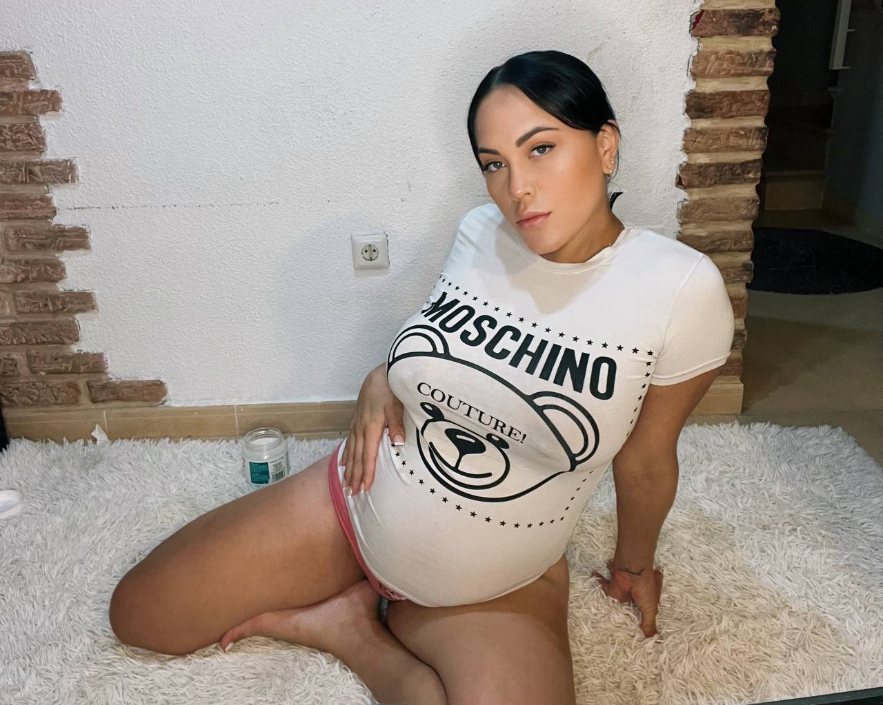 A Pregnant Woman In A T-Shirt At Home